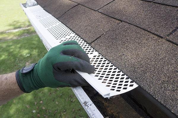 installing gutter guards can help prevent clogs and debris buildup in your gutters